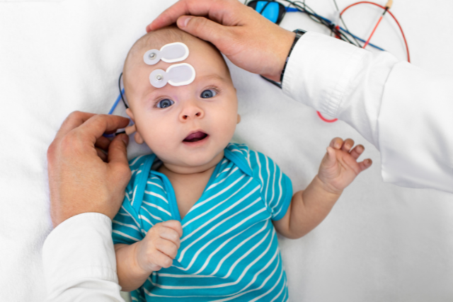 Infant having testing administered in doctors office